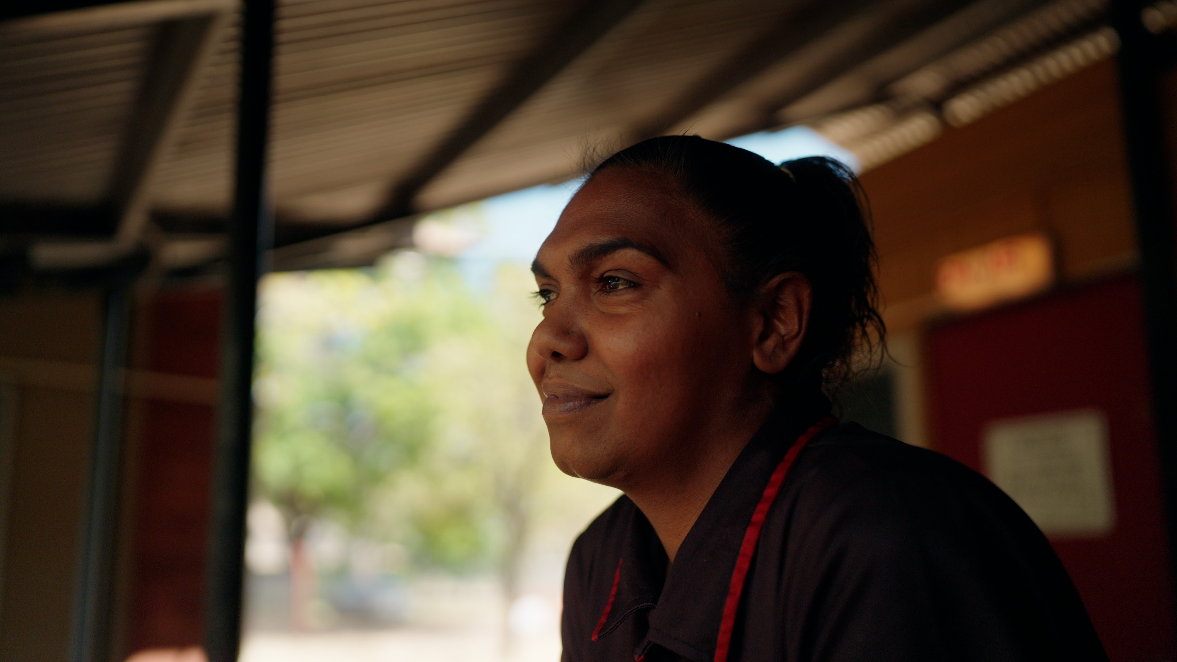 Nathalia looks out from under a shed