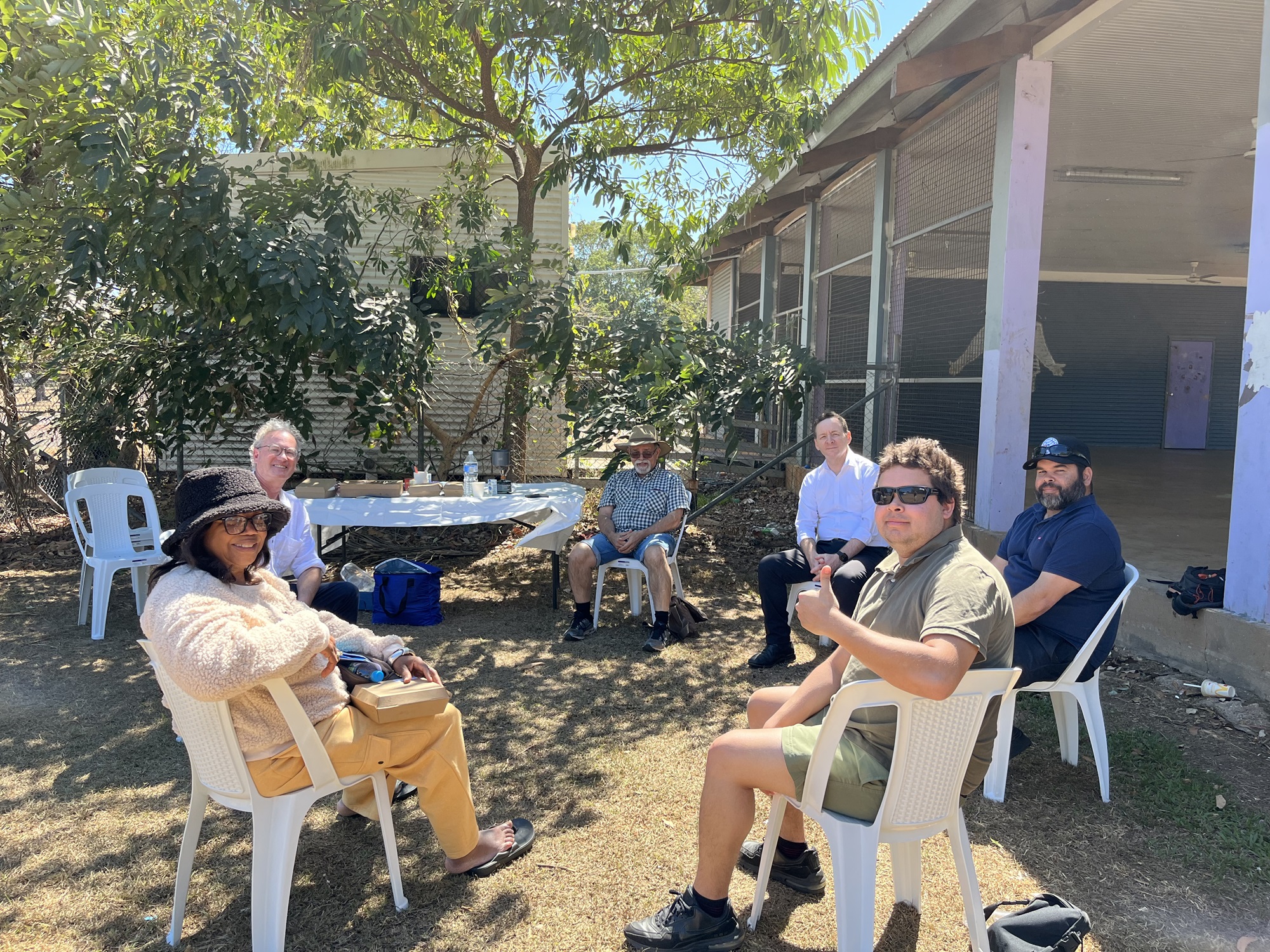 A group of people in a circle in a backyard