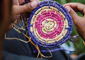 An item being weaved with raffia