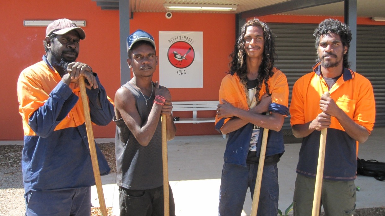 a photo of 4 local employees standing in front of the new store they helped construct in Peppimenarti