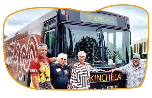 Jody Broun and 3 survivors of the Kinchela Boys Home in front of a bus
